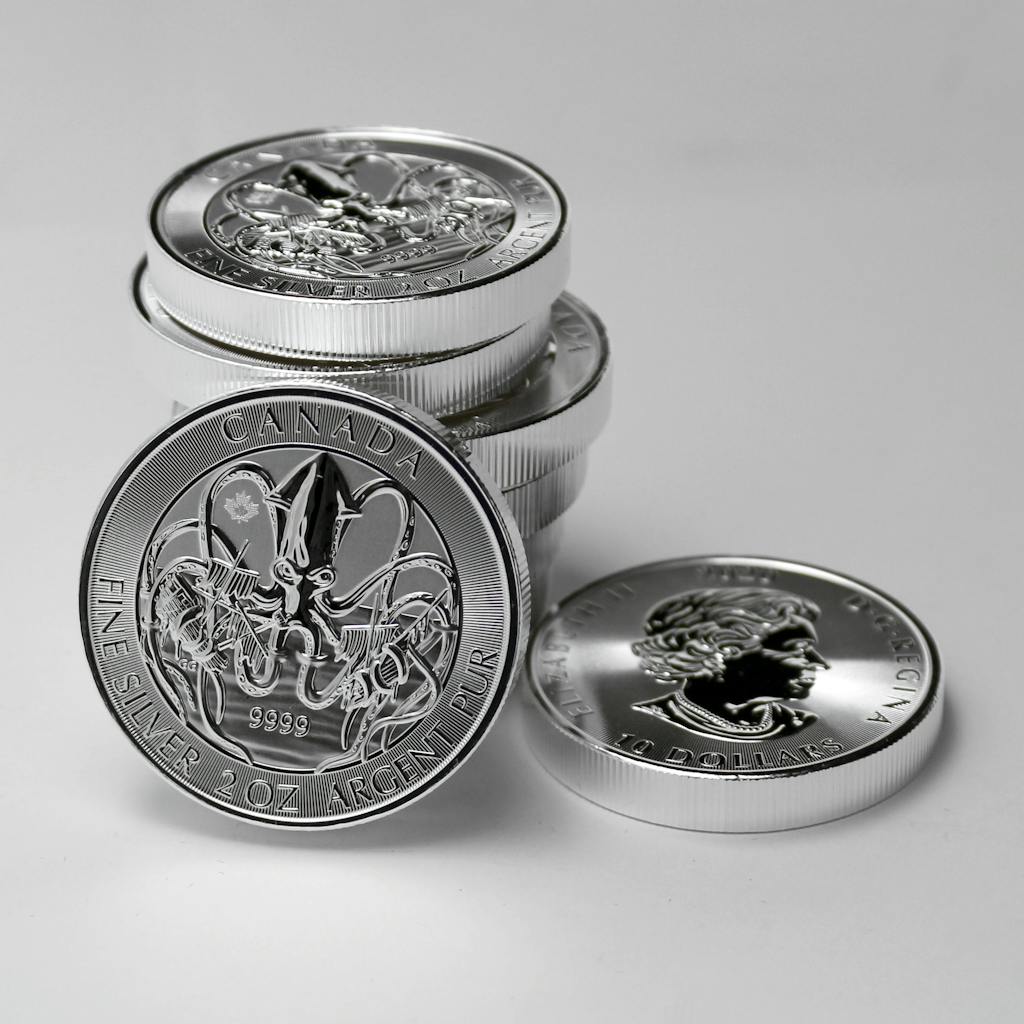 Close-up of Canadian silver coins highlighting intricate designs and monetary value.