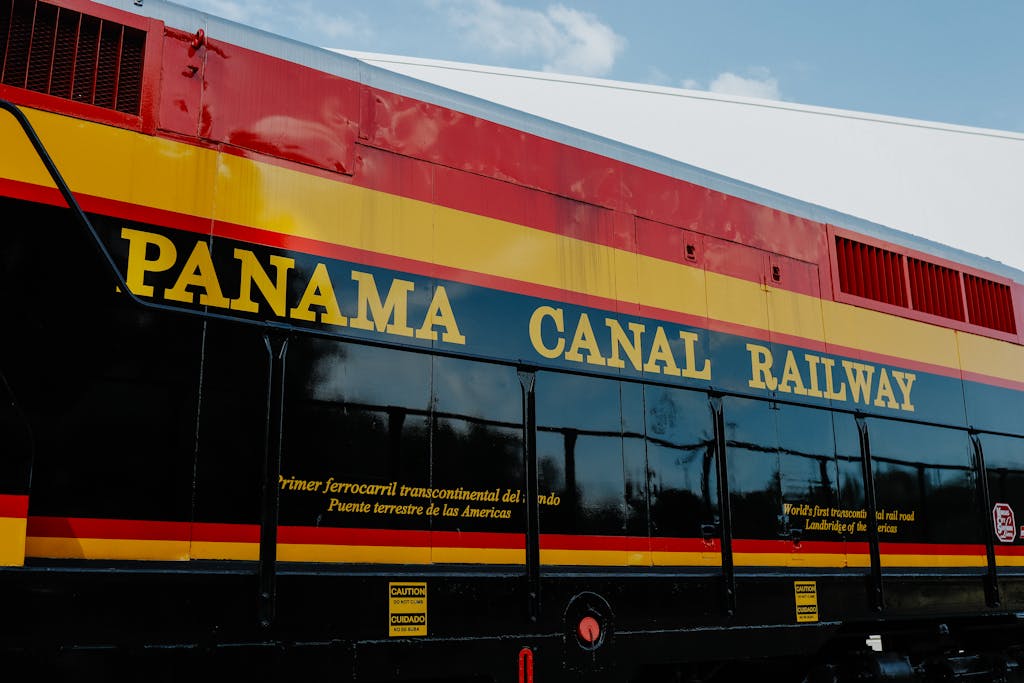 Close-up view of Panama Canal Railway train displaying vibrant colors and signage.
