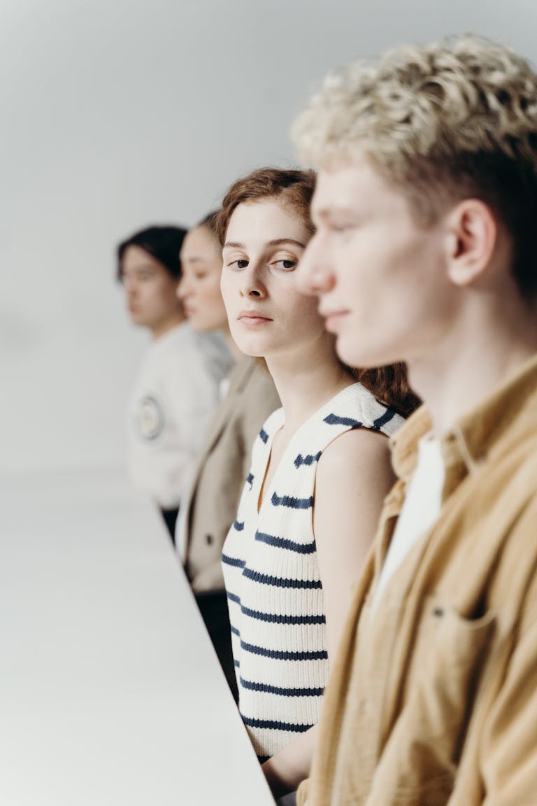 A diverse group of professionals engaged in conversation around a table, showcasing teamwork and collaboration.