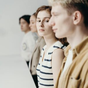 A diverse group of professionals engaged in conversation around a table, showcasing teamwork and collaboration.