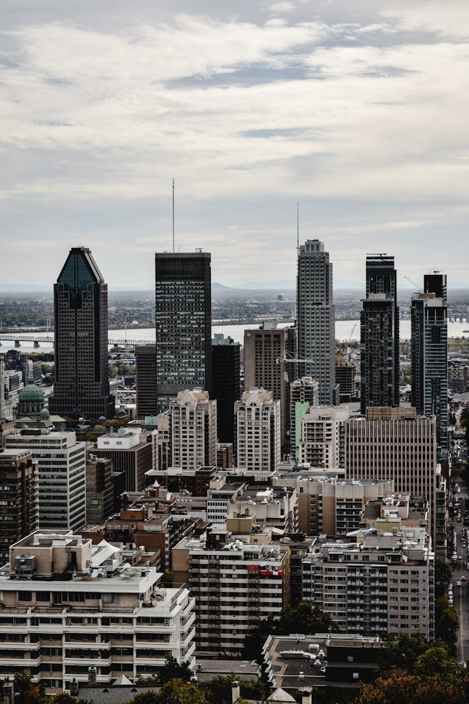 A stunning view of Montreal's skyline with the St. Lawrence River in the background, showcasing urban architecture.
