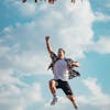 A vibrant image of a young man jumping with joy outdoors, capturing a moment of freedom and exhilaration.