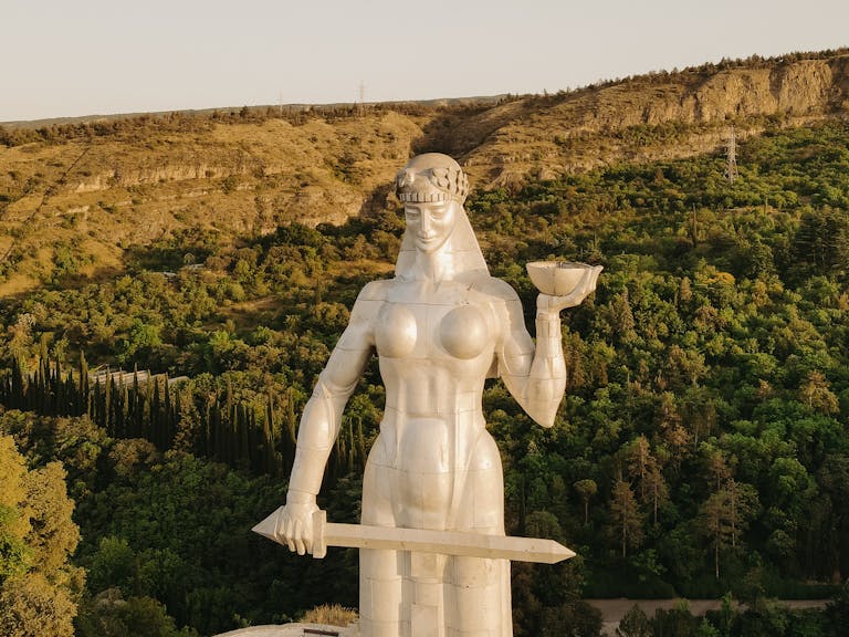 Aerial view of the iconic Mother of Georgia statue overlooking Tbilisi, Georgia.
