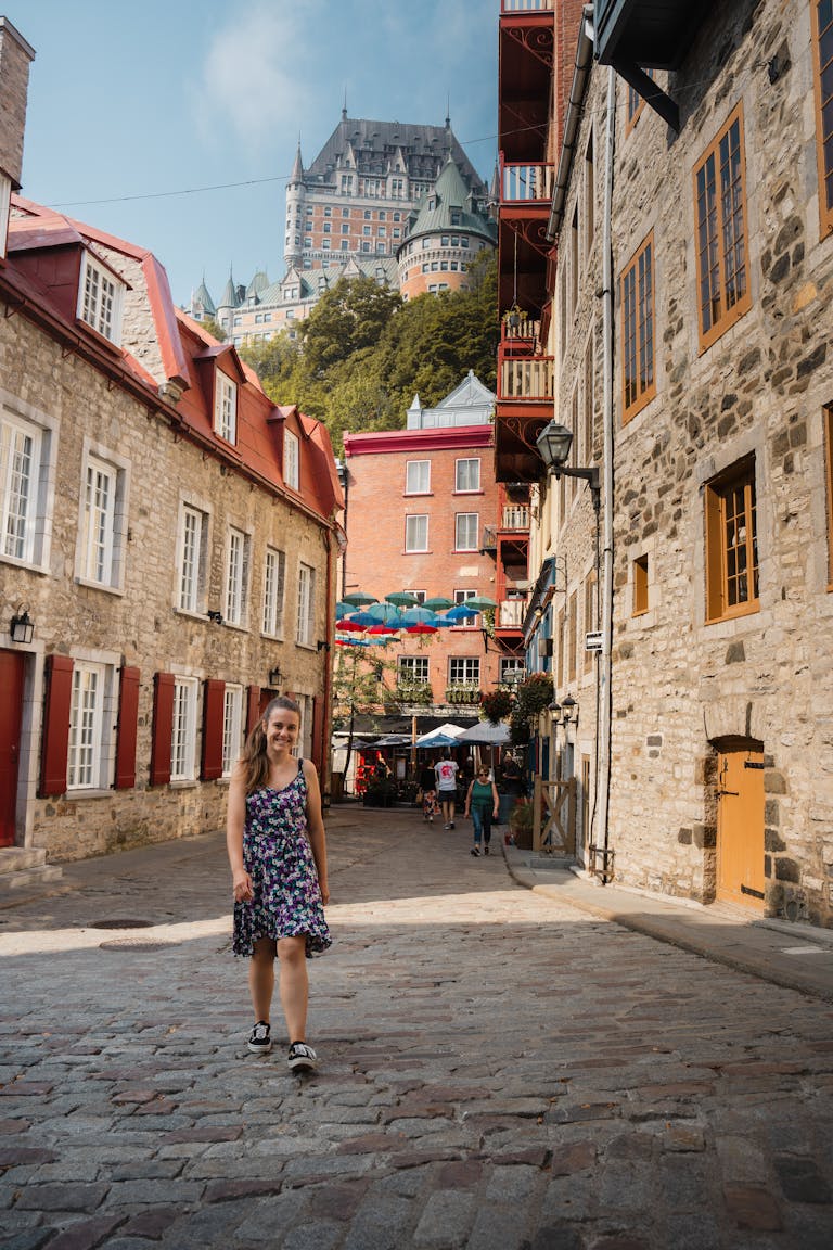 Charming street view with Château Frontenac in Québec City, featuring cobblestones and historic architecture.