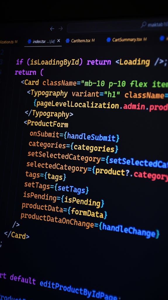 Close-up of JSX code on a monitor, showcasing colorful syntax used in ReactJS development.